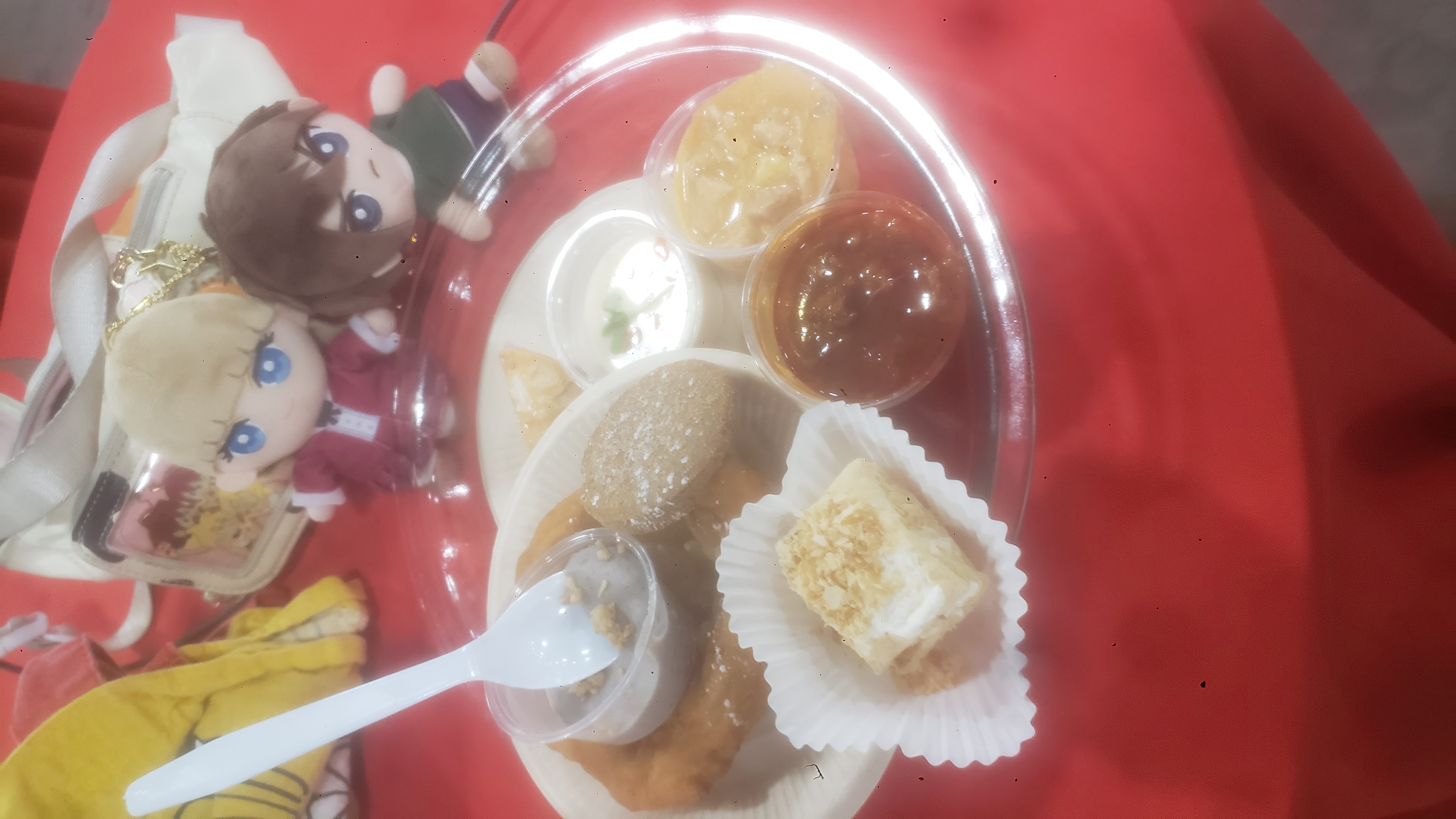 Mini cups of soup and mini desserts in a pie pan on a table.